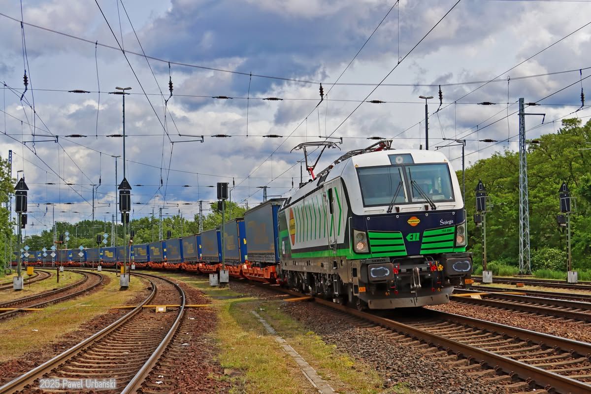 PKP Cargo Siemens Vectron electric locomotive hauling intermodal freight containers on railway tracks in Poland